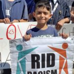 Child holding RID banner